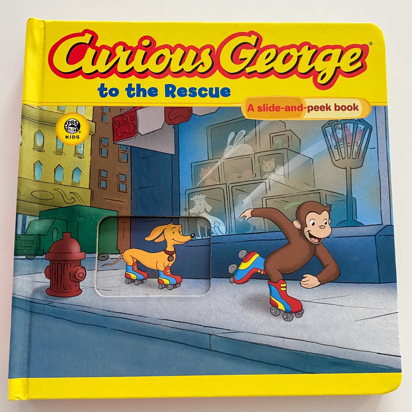 Curious George To The Rescue Slide & Peek Board Book